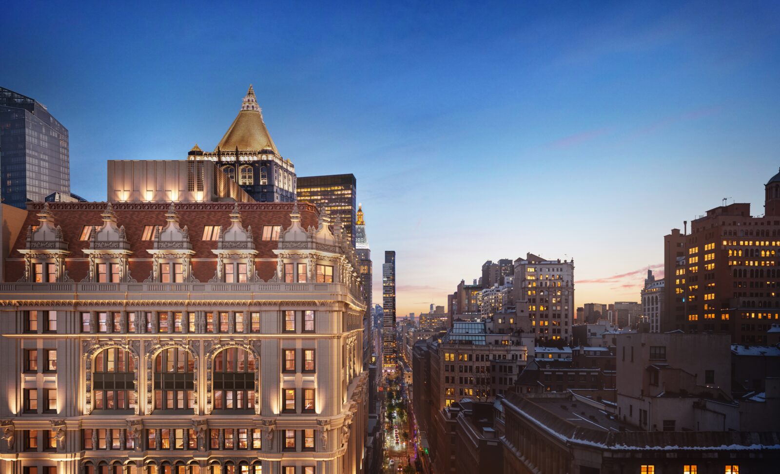 95 Madison illuminated above Madison Avenue at dusk